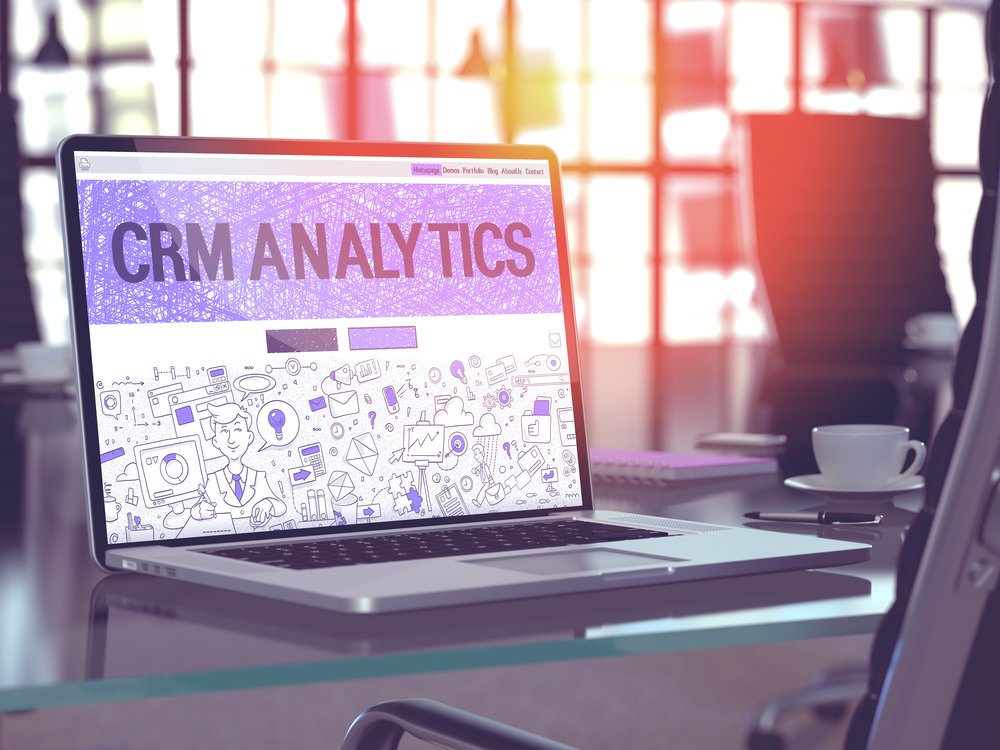 CRM Analytics - Closeup Landing Page in Doodle Design Style on Laptop Screen. On Background of Comfortable Working Place in Modern Office. Toned, Blurred Image. 3D Render.