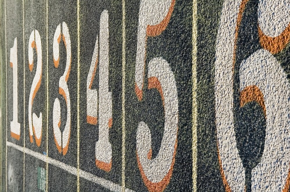 Numbers one through six painted on lanes of weathered track